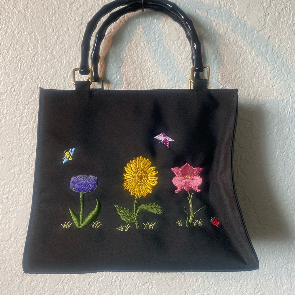 Black purse with embroidered flowers